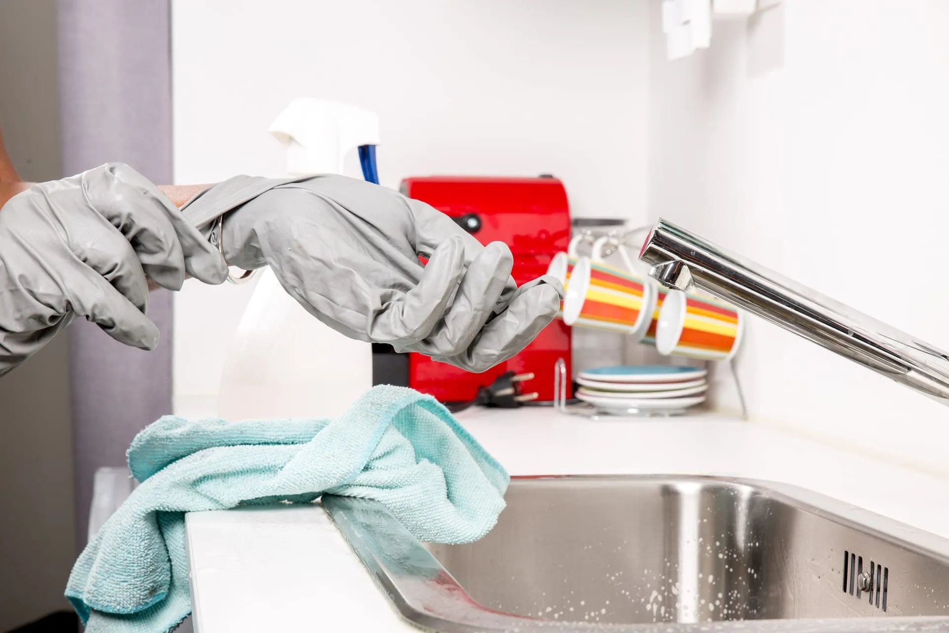 Taking off gloves next to sink